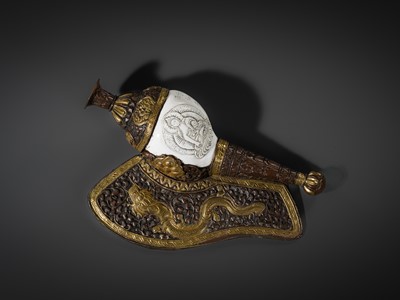 Lot 29 - A CARVED CONCH-SHELL TRUMPET, DUNG DKAR, WITH PARCEL-GILT COPPER REPOUSSÉ MOUNT