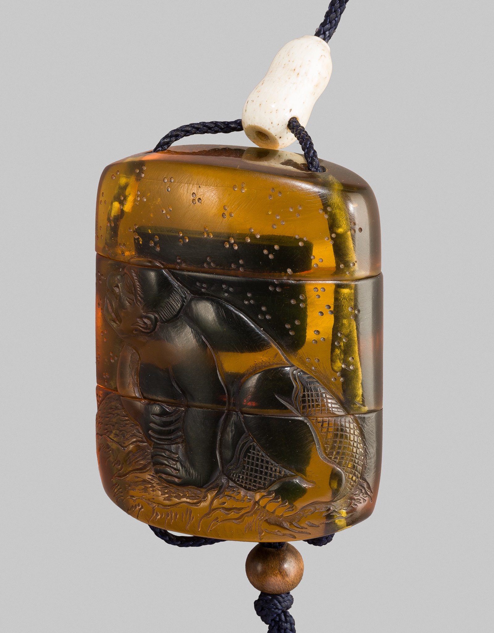 Lot 228 - A VERY RARE AMBER TWO-CASE INRO DEPICTING