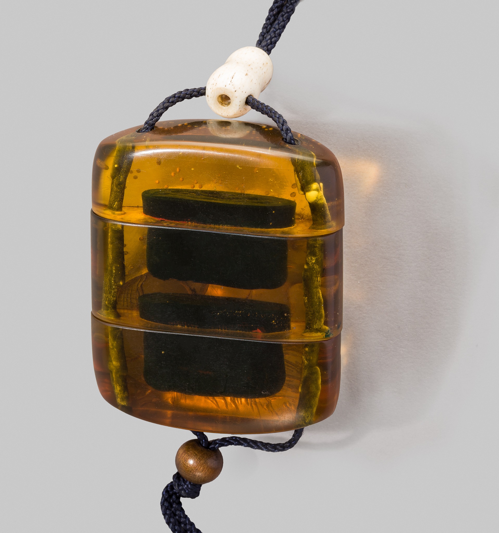 Lot 228 - A VERY RARE AMBER TWO-CASE INRO DEPICTING