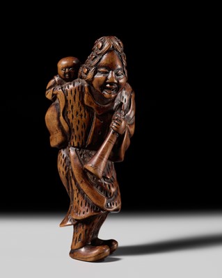 A WOOD NETSUKE OF A DUTCHMAN WITH A CHILD