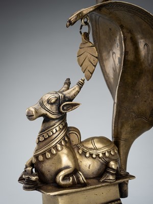 Lot 985 - A BRONZE FIGURE NANDI CANOPIED BY A CROWNED NAGA, 19TH CENTURY