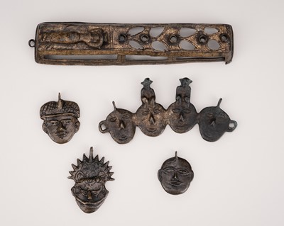 Lot 2128 - A GROUP OF NAGALAND TRIBAL MASK ORNAMENTS AND A GILT-BRONZE WALL HANGING, c. 1900s