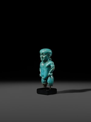 Lot 45 - A TURQUOISE-GLAZED FAIENCE AMULET OF PATAIKOS, LATE PERIOD