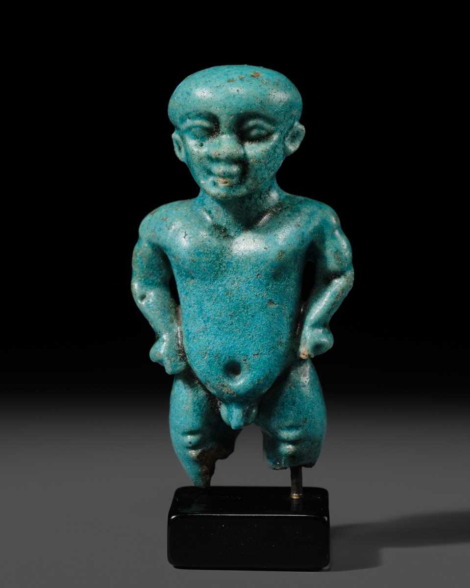Lot 45 - A TURQUOISE-GLAZED FAIENCE AMULET OF PATAIKOS, LATE PERIOD