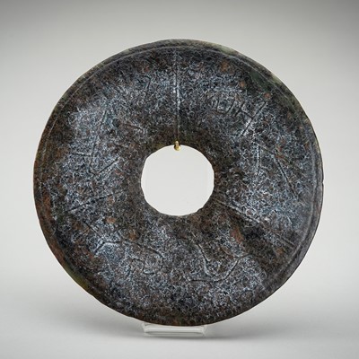 Lot 1710 - A GREEN AND BROWN JADE DISK, BI, NEOLITHIC OR LATER