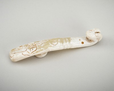 AN ARCHAISTIC CELADON JADE ‘CHILONG’ BELT HOOK