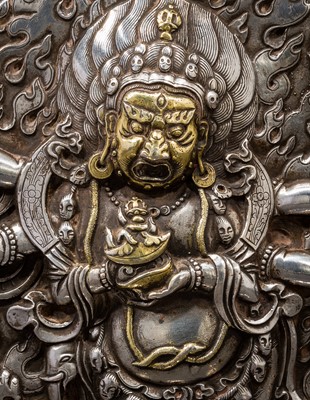 Lot 308 - A PARCEL-GILT SILVER REPOUSSÉ GAU DEPICTING SHADBHUJA MAHAKALA, BHUTAN, 19TH CENTURY