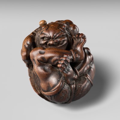 Lot 151 - ITTAN: A SUPERB WOOD NETSUKE OF A COWERING ONI DURING SETSUBUN