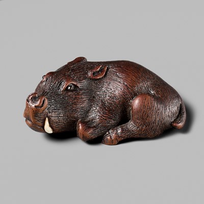 Lot 145 - ICHIUN: A FINE WOOD NETSUKE OF A RECUMBENT BOAR