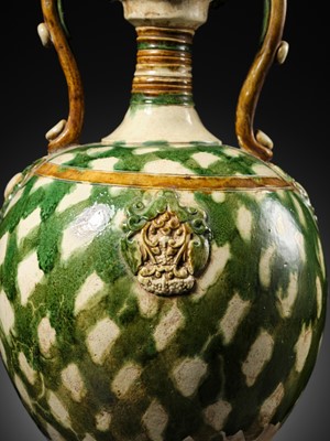 Lot 137 - A SANCAI-GLAZED APPLIQUÉ-DECORATED DRAGON-HANDLED AMPHORA, TANG DYNASTY