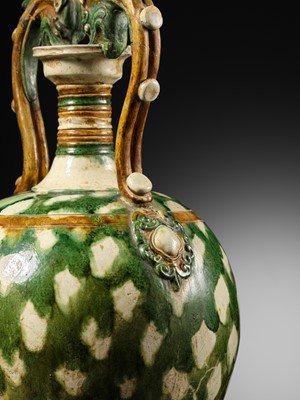 Lot 137 - A SANCAI-GLAZED APPLIQUÉ-DECORATED DRAGON-HANDLED AMPHORA, TANG DYNASTY