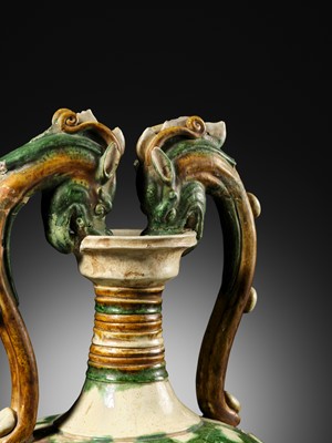 Lot 137 - A SANCAI-GLAZED APPLIQUÉ-DECORATED DRAGON-HANDLED AMPHORA, TANG DYNASTY