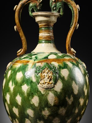 Lot 137 - A SANCAI-GLAZED APPLIQUÉ-DECORATED DRAGON-HANDLED AMPHORA, TANG DYNASTY