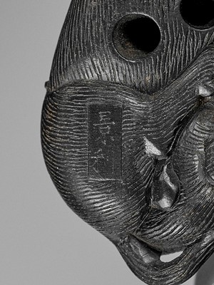 Lot 158 - KAGETOSHI: AN EXQUISITE EBONY WOOD AND IVORY NETSUKE OF AN OX WITH BOKUDO