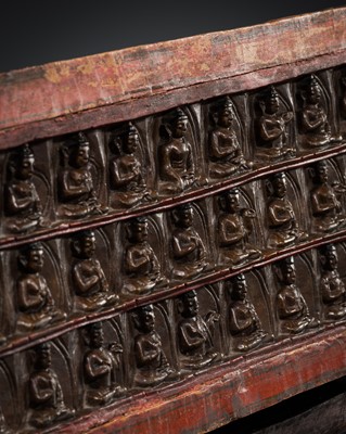 Lot 286 - A CARVED AND LACQUERED “36 BUDDHAS” WOODEN SUTRA COVER, TIBET, 13TH-14TH CENTURY