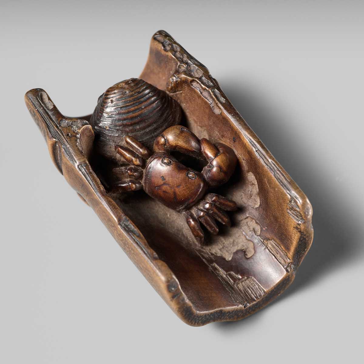 Lot 172 - HOKUTEI: A WOOD NETSUKE OF A CRAB AND A CLAM IN A SEGMENT OF BAMBOO