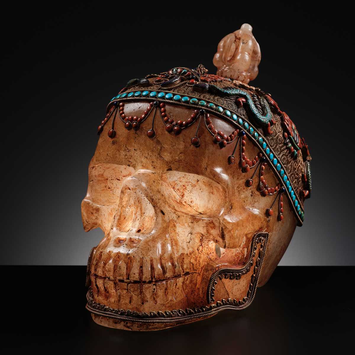 Lot 56 - A MONUMENTAL AND RARE ROCK CRYSTAL SKULL WEARING A GEMSTONE-INLAID GILT-METAL FILIGREE CROWN, 19TH TO FIRST HALF OF 20TH CENTURY