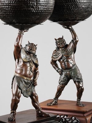Lot 54 - AKASOFU GYOKKO: A PAIR OF IMPRESSIVE AND LARGE PARCEL-GILT BRONZE FIGURES OF ONI HOLDING ALOFT SOUND BOWLS