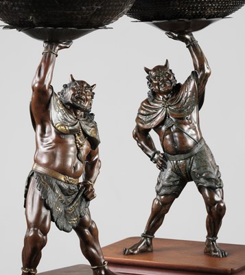 Lot 13 - AKASOFU GYOKKO: A PAIR OF IMPRESSIVE AND LARGE PARCEL-GILT BRONZE FIGURES OF ONI HOLDING ALOFT SOUND BOWLS