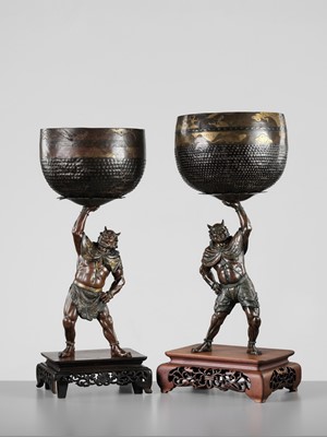 Lot 54 - AKASOFU GYOKKO: A PAIR OF IMPRESSIVE AND LARGE PARCEL-GILT BRONZE FIGURES OF ONI HOLDING ALOFT SOUND BOWLS