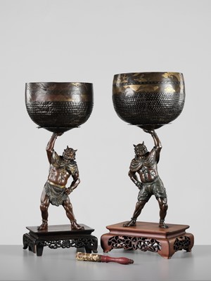 Lot 54 - AKASOFU GYOKKO: A PAIR OF IMPRESSIVE AND LARGE PARCEL-GILT BRONZE FIGURES OF ONI HOLDING ALOFT SOUND BOWLS