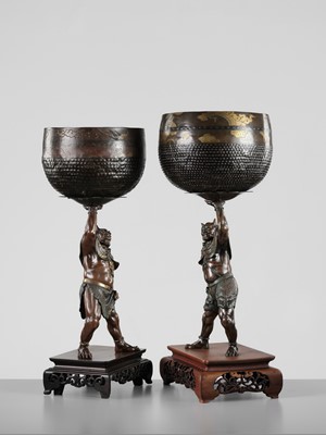Lot 54 - AKASOFU GYOKKO: A PAIR OF IMPRESSIVE AND LARGE PARCEL-GILT BRONZE FIGURES OF ONI HOLDING ALOFT SOUND BOWLS