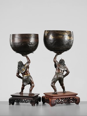 Lot 54 - AKASOFU GYOKKO: A PAIR OF IMPRESSIVE AND LARGE PARCEL-GILT BRONZE FIGURES OF ONI HOLDING ALOFT SOUND BOWLS