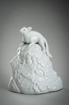 Lot 187 - A HIRADO WHITE-GLAZED PORCELAIN OKIMONO OF A SQUIRREL AND GRAPES