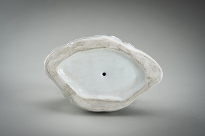 Lot 187 - A HIRADO WHITE-GLAZED PORCELAIN OKIMONO OF A SQUIRREL AND GRAPES