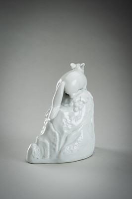 Lot 187 - A HIRADO WHITE-GLAZED PORCELAIN OKIMONO OF A SQUIRREL AND GRAPES