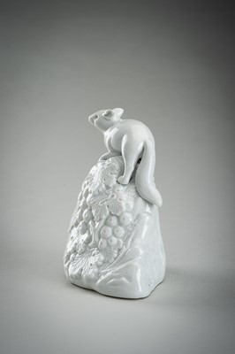 Lot 187 - A HIRADO WHITE-GLAZED PORCELAIN OKIMONO OF A SQUIRREL AND GRAPES