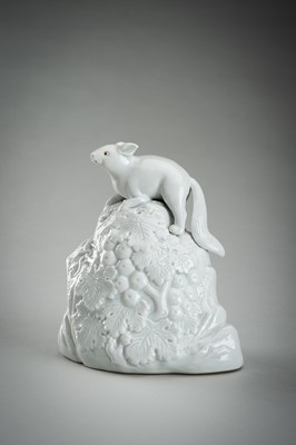 Lot 187 - A HIRADO WHITE-GLAZED PORCELAIN OKIMONO OF A SQUIRREL AND GRAPES