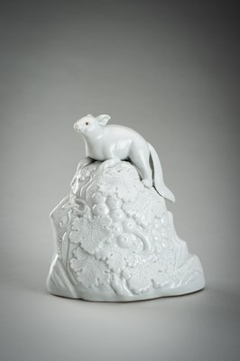 Lot 187 - A HIRADO WHITE-GLAZED PORCELAIN OKIMONO OF A SQUIRREL AND GRAPES