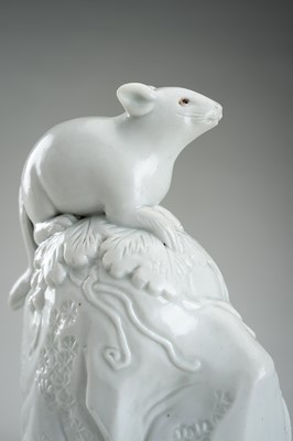 Lot 187 - A HIRADO WHITE-GLAZED PORCELAIN OKIMONO OF A SQUIRREL AND GRAPES