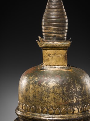 Lot 117 - A GILT COPPER ALLOY RELIQUARY SVAYAMBHU STUPA, NEPAL, 17TH-18TH CENTURY