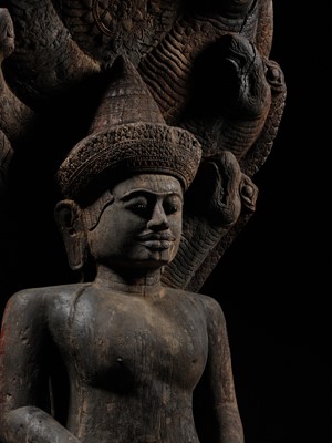 Lot 40 - A MONUMENTAL (215 CM HIGH) AND IMPORTANT WOOD SCULPTURE OF BUDDHA MUCHALINDA, POST-ANGKORIAN PERIOD
