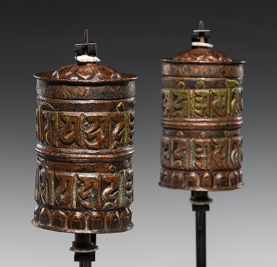 Lot 179 - A PAIR OF COPPER REPOUSSÉ PRAYER WHEELS, 18TH-19TH CENTURY