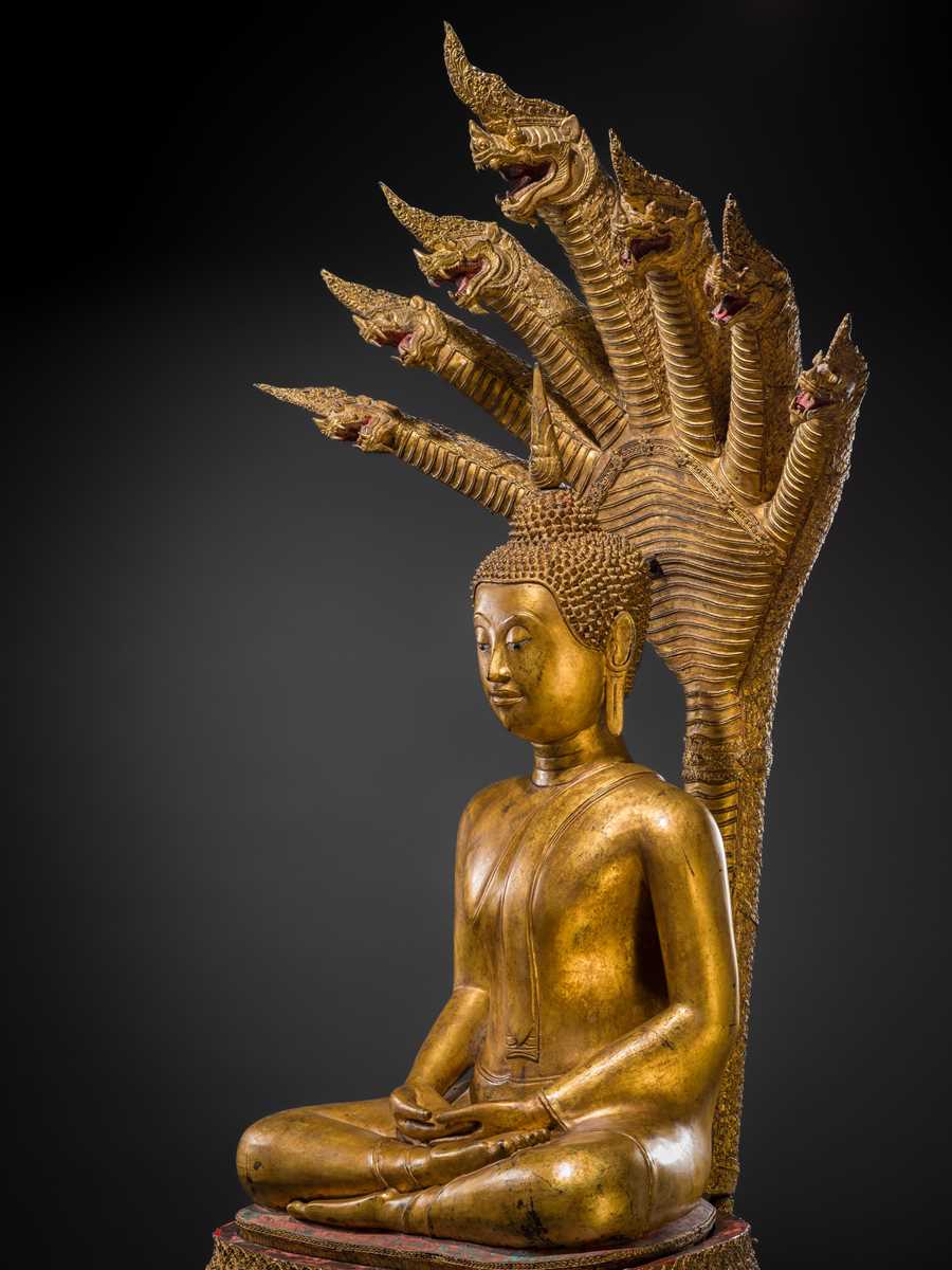 Lot 33 - A MONUMENTAL (194 CM HIGH) GILT-LACQUERED BRONZE FIGURE OF BUDDHA MUCHALINDA, RATTANAKOSIN PERIOD
