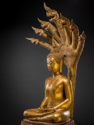 Lot 33 - A MONUMENTAL (194 CM HIGH) GILT-LACQUERED BRONZE FIGURE OF BUDDHA MUCHALINDA, RATTANAKOSIN PERIOD
