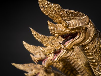 Lot 33 - A MONUMENTAL (194 CM HIGH) GILT-LACQUERED BRONZE FIGURE OF BUDDHA MUCHALINDA, RATTANAKOSIN PERIOD