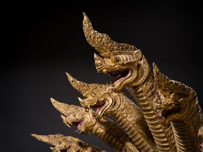 Lot 33 - A MONUMENTAL (194 CM HIGH) GILT-LACQUERED BRONZE FIGURE OF BUDDHA MUCHALINDA, RATTANAKOSIN PERIOD