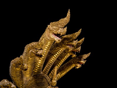 Lot 33 - A MONUMENTAL (194 CM HIGH) GILT-LACQUERED BRONZE FIGURE OF BUDDHA MUCHALINDA, RATTANAKOSIN PERIOD