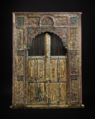 Lot 94 - A LARGE CARVED POLYCHROME WOOD ARCHED DOORWAY, GUJARAT, LATE 19TH CENTURY