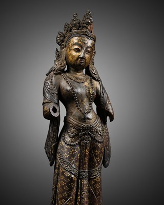 Lot 22 - A RARE PARCEL-GILT AND LACQUERED ZITAN FIGURE OF TARA, BHUTAN, 17TH - 18TH CENTURY