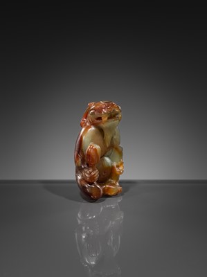 Lot 446 - A CELADON AND RUSSET JADE ‘MYTHICAL BEAST’ PENDANT, MING DYNASTY