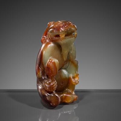 Lot 446 - A CELADON AND RUSSET JADE ‘MYTHICAL BEAST’ PENDANT, MING DYNASTY