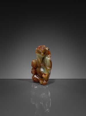 Lot 446 - A CELADON AND RUSSET JADE ‘MYTHICAL BEAST’ PENDANT, MING DYNASTY