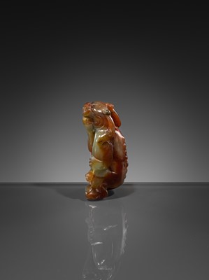 Lot 446 - A CELADON AND RUSSET JADE ‘MYTHICAL BEAST’ PENDANT, MING DYNASTY