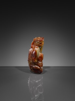 Lot 446 - A CELADON AND RUSSET JADE ‘MYTHICAL BEAST’ PENDANT, MING DYNASTY