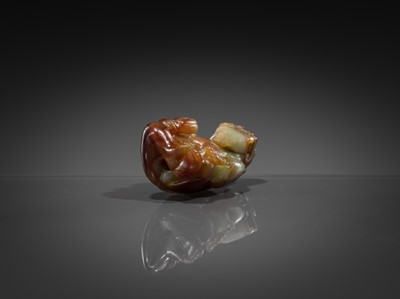 Lot 446 - A CELADON AND RUSSET JADE ‘MYTHICAL BEAST’ PENDANT, MING DYNASTY